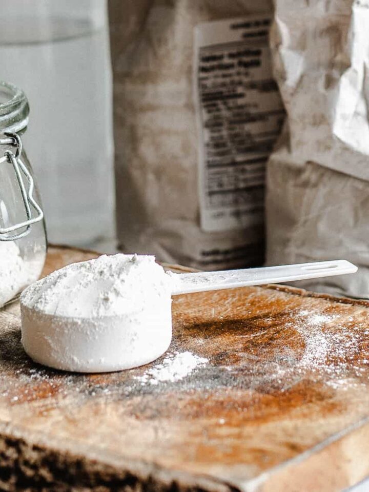 White flour in a small mason jar and white flour in small white measuring cup