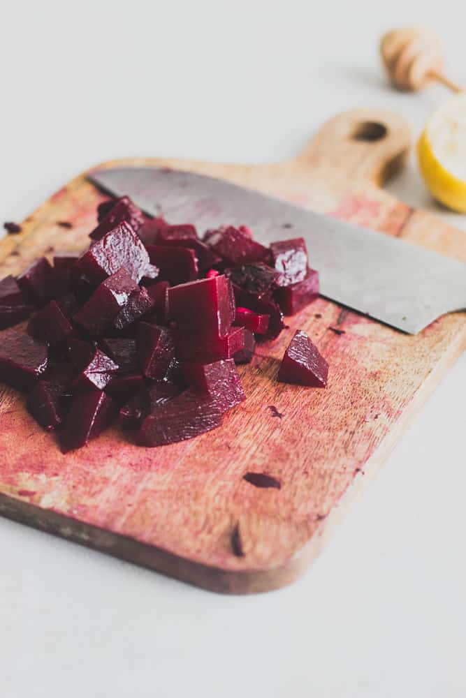 Diced cooked beets on a cutting board