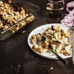 Vegan stuffing on a salad plate with the stuffing's casserole dish in the background