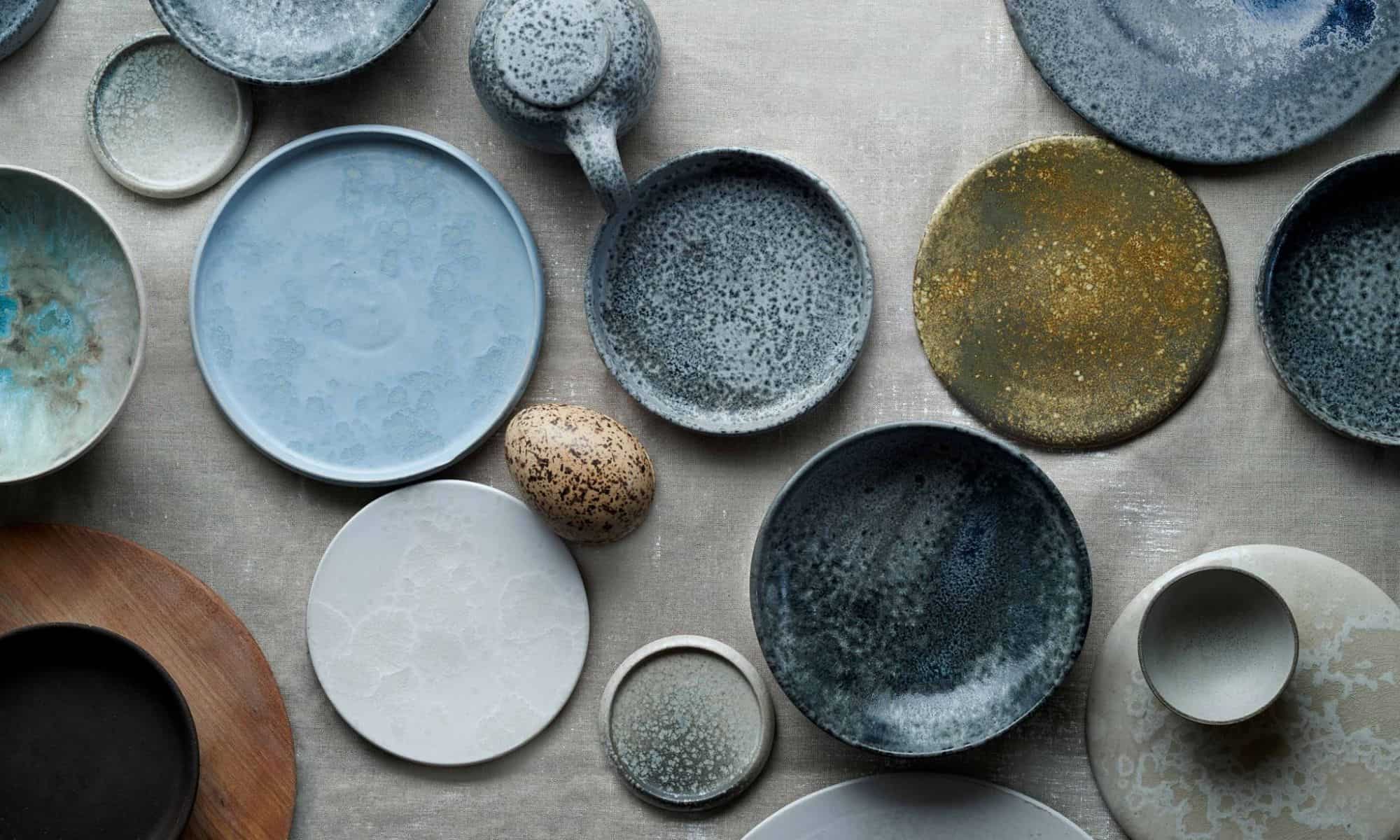 Bird's eye view of rustic plates of different shades of grey