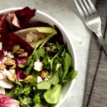 Top view of two bols of radicchio and endive salad with pistachios and almond ricotta