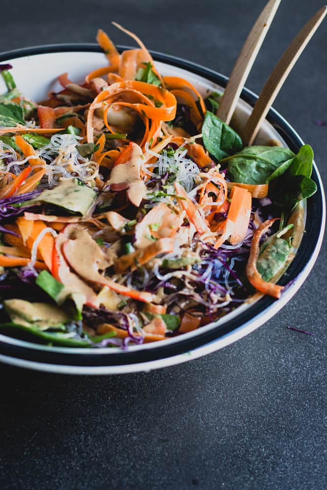 Thai salad in a bog white bowl with mock peanut sauce