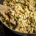 Close-up shot of a wooden spoon lifting up creamy corn fusilli