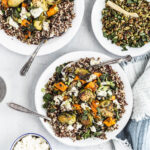 A plate of quinoa, Brussels sprouts, and sweet potato mixed with vegetable ricotta-style cheese