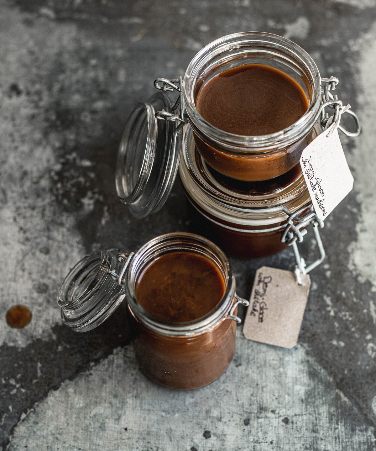 Three small jars containing demi-glace