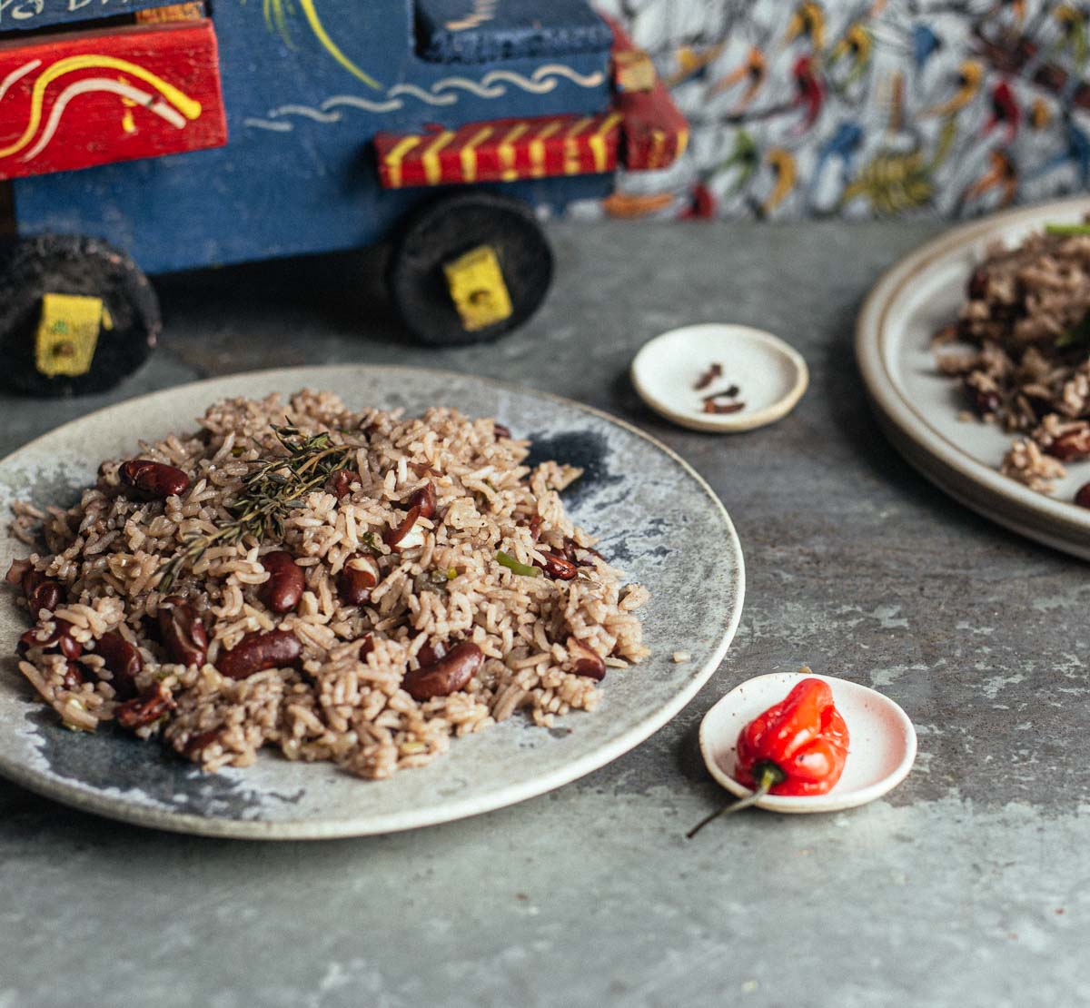 Two plates of Haitian rice and beans.