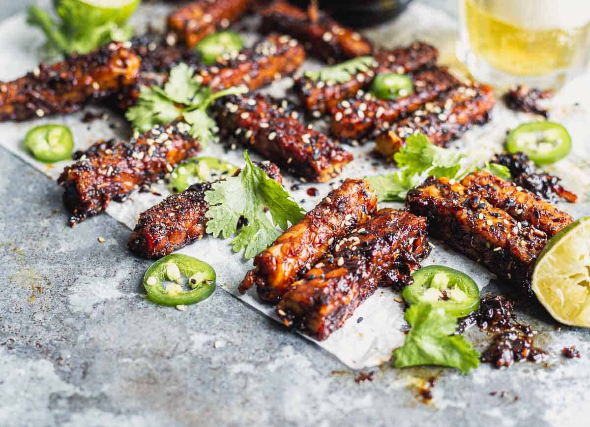 Sticky tempeh sticks on parchment paper. 